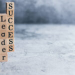 Wood cube letter word of Leader, teamwork, and success with copy space. Idea of motivation or inspiration in business vision and corporate management strategy. Leadership lead team to reach goal.
